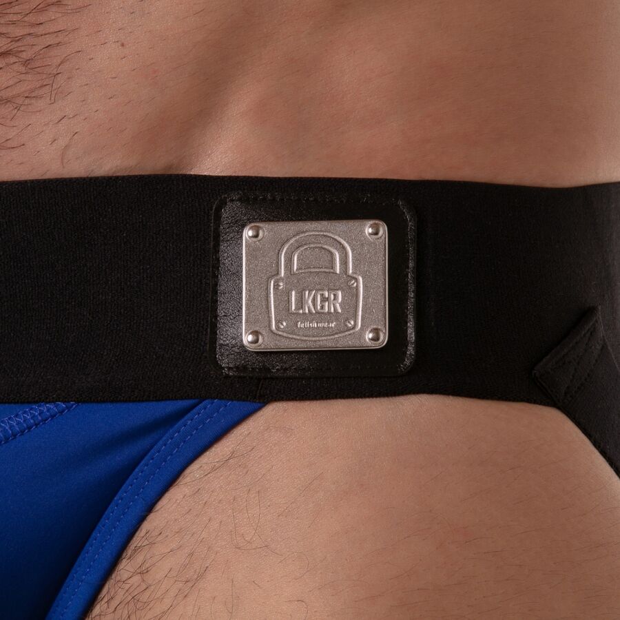 Gros plan sur la plaque métallique Locker Gear fixée à la ceinture du jockstrap bleu