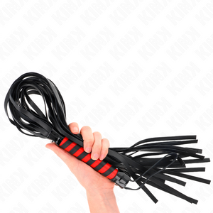 Red and black KINK flogger held in one hand, with the long black tails folded around the handle