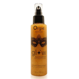 Huile corporelle dorée Glow dans son flacon spray transparent à pompe noire